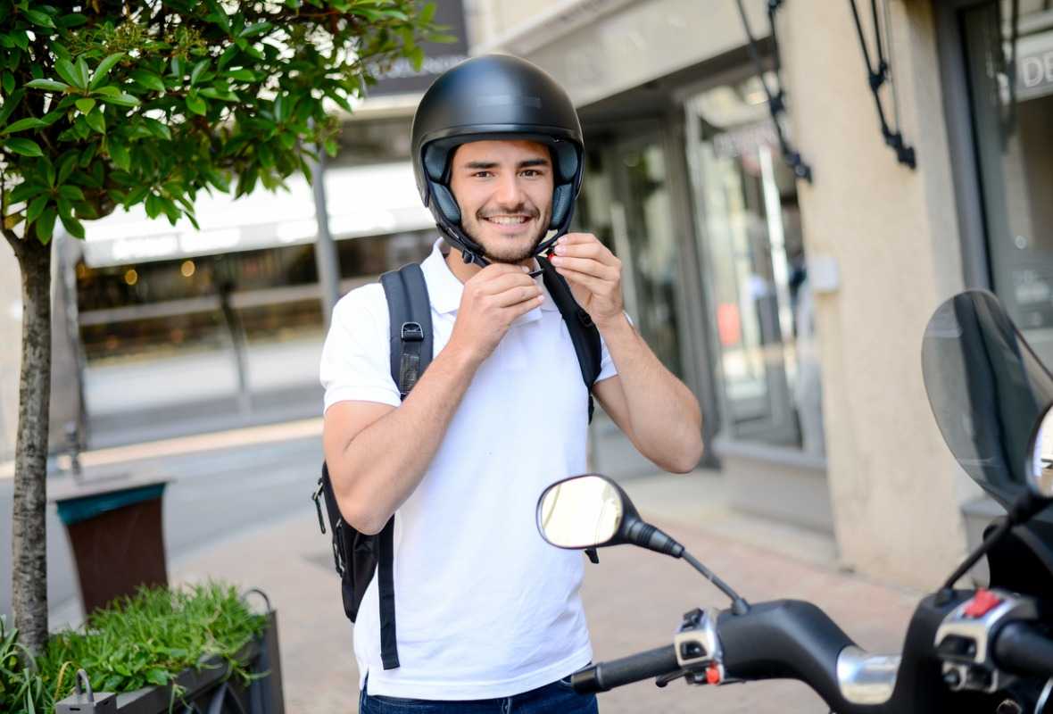 Hombre apoyado en su moto 